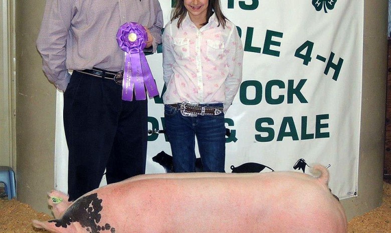 Logan Jennings with the Grand Champion at the 2013 Albemarle 4-H Livestock Show