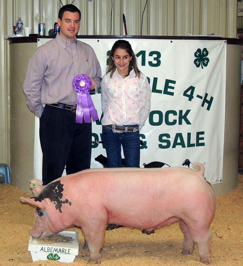 Logan Jennings with the Grand Champion at the 2013 Albemarle 4-H Livestock Show