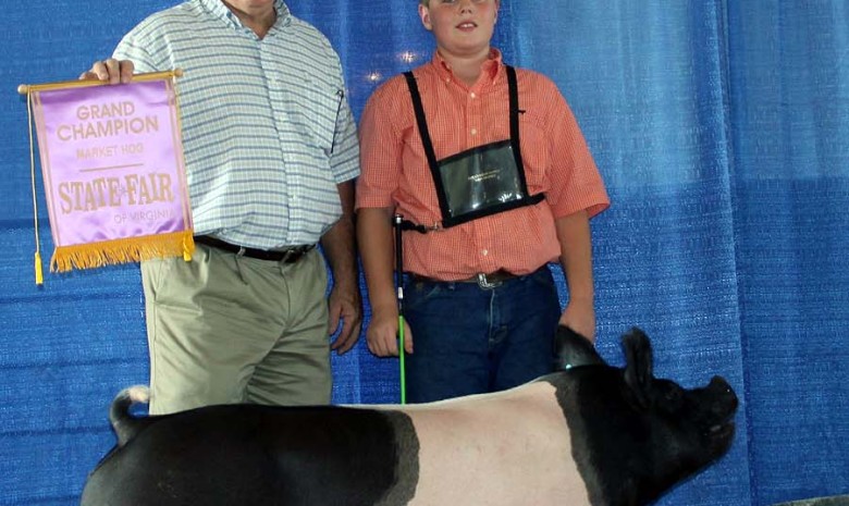 Zach McCall with the Grand Champion Market Hog at the 2013 Virginia State Fair