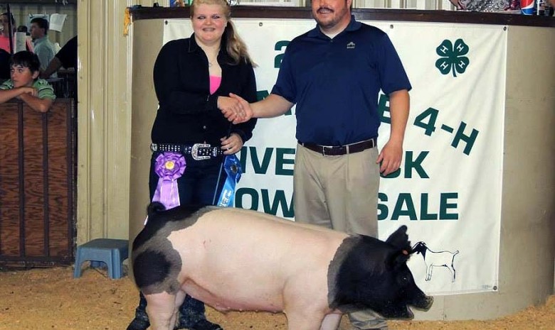 The Grand Champion Market Hog at the 2014 Albemarle 4-H Livestock Show shown by Haley Stevenson and the Harris Family