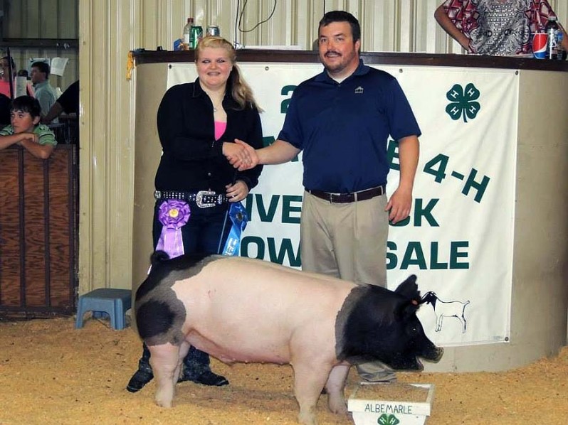 The Grand Champion Market Hog at the 2014 Albemarle 4-H Livestock Show shown by Haley Stevenson and the Harris Family